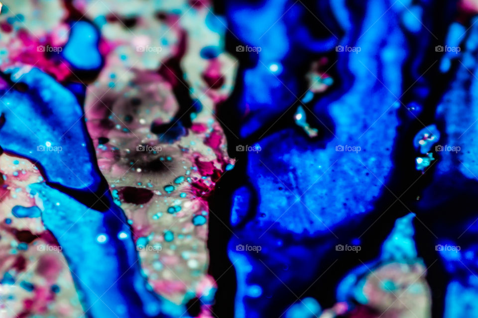 The ink to refill the printer cartridge was spilled onto the white washbasin and the paints blended into abstract drips and patterns.