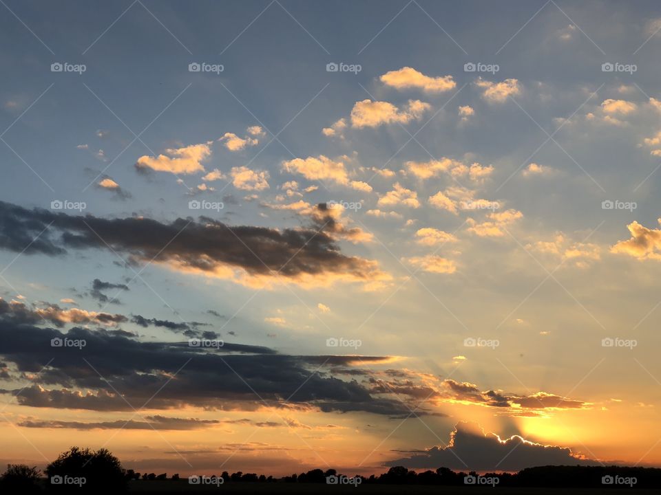 Prairie sunset with  approaching rain clouds