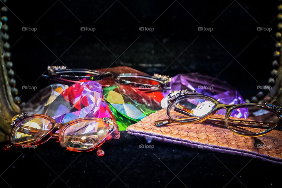 The three pairs of glasses at the multiple colored glass and purse