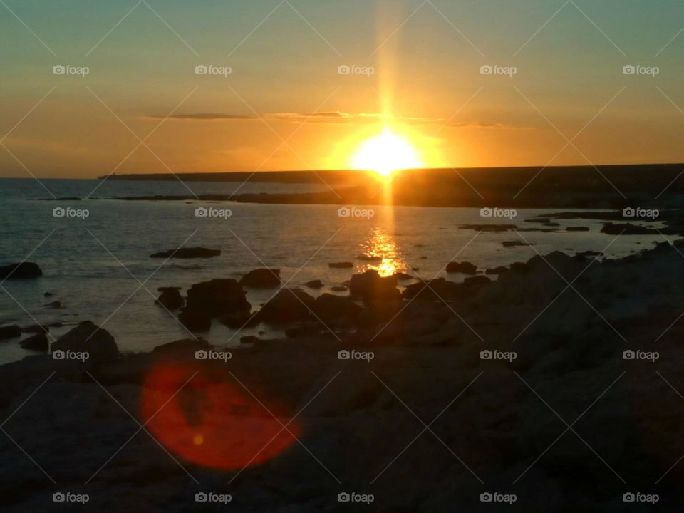 beautiful sunset on a sea stone shore