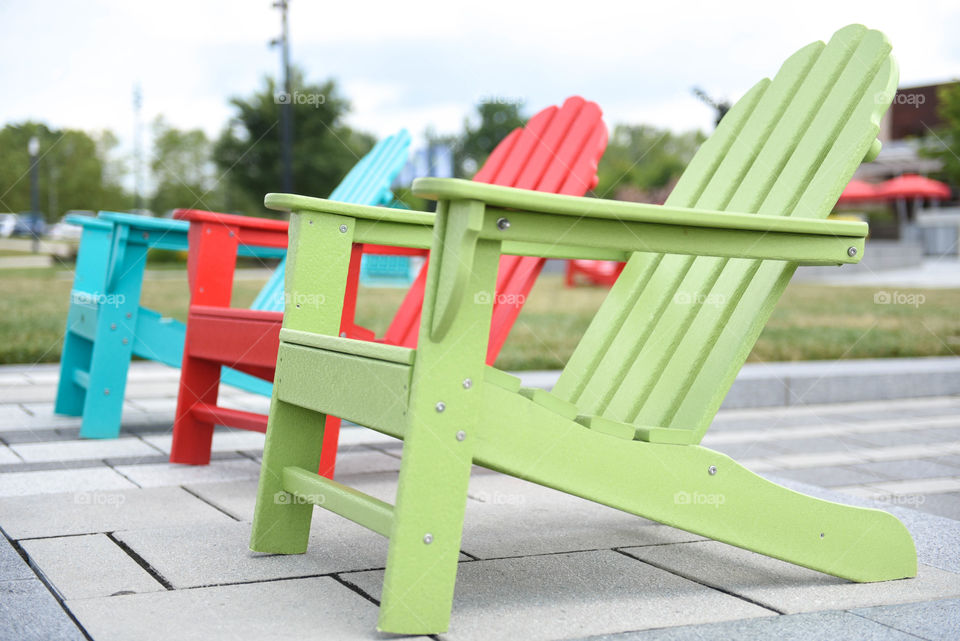 Row of different colored lounge chairs outdoors