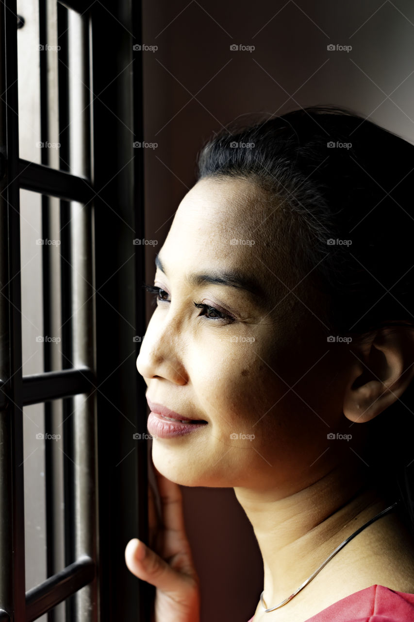 Beautiful lady looking out the window