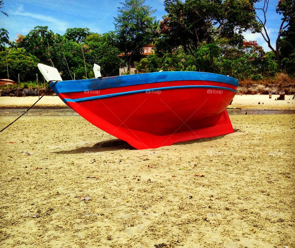 red boat anchored at Catu beach, Itaparica island