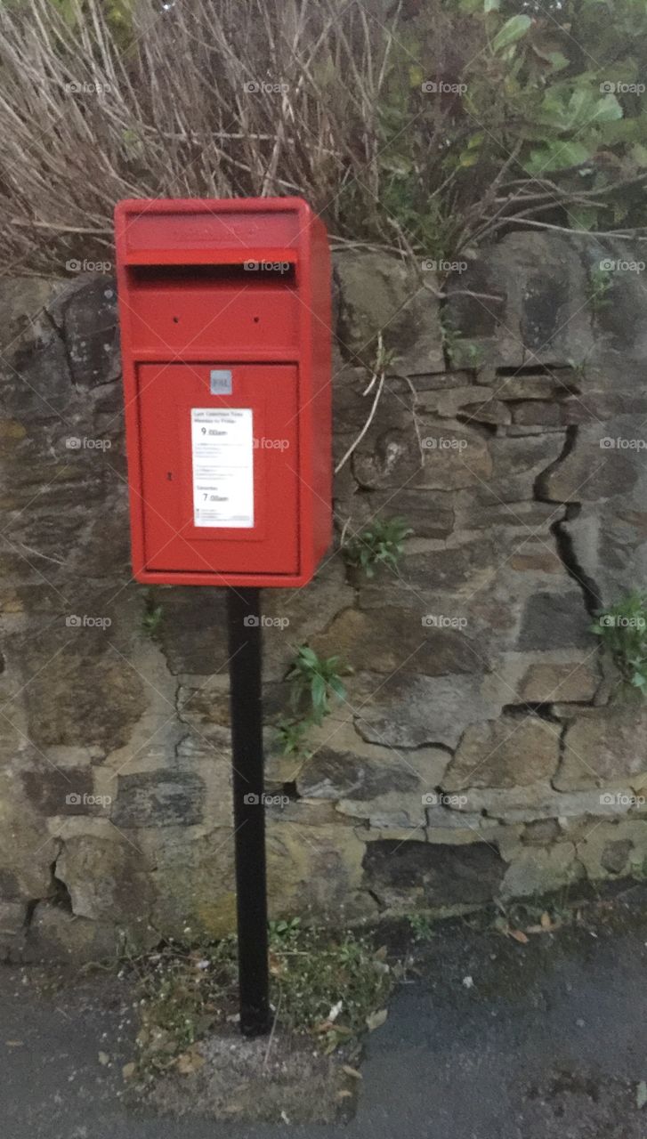 The post box against a cracked wall .