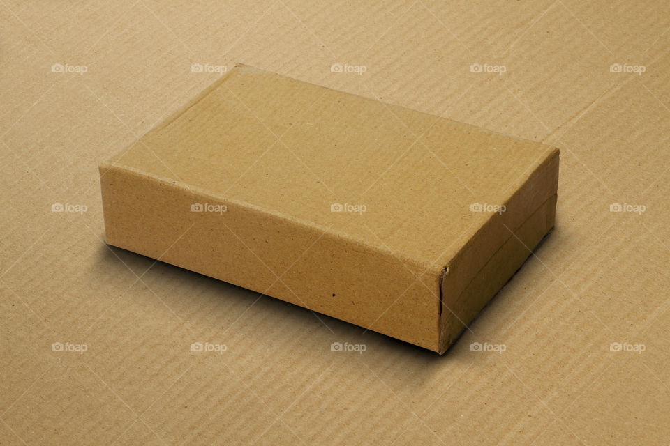 Brown recycled Cardboard box on brown corrugated cardboard