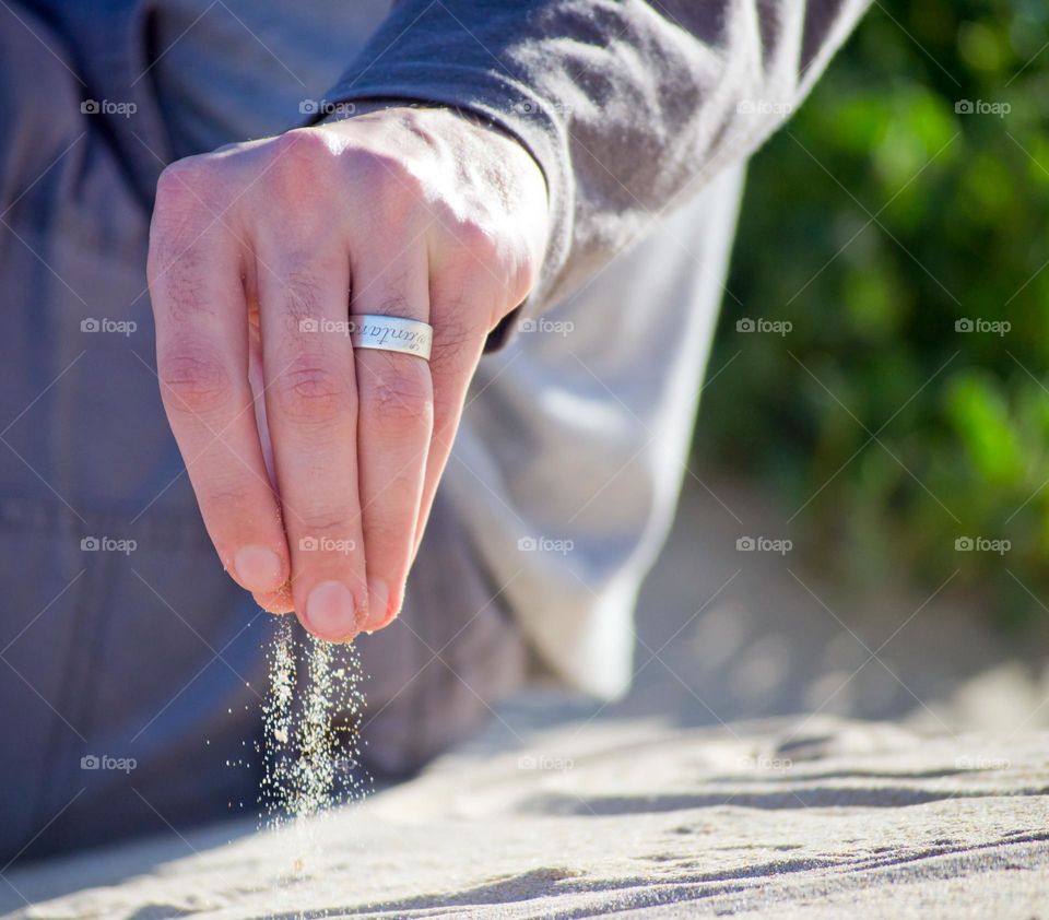 Sifting sand hand man