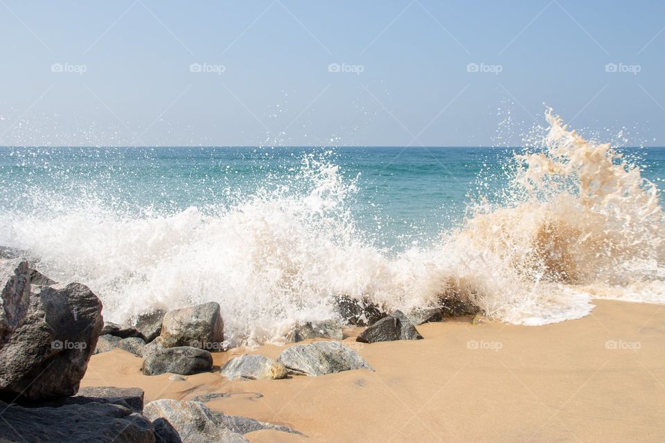 beach waves slashing against the rocks.