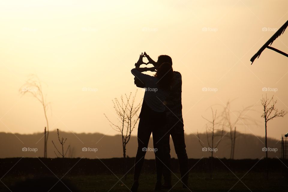 Young loving couple shoot sunset 