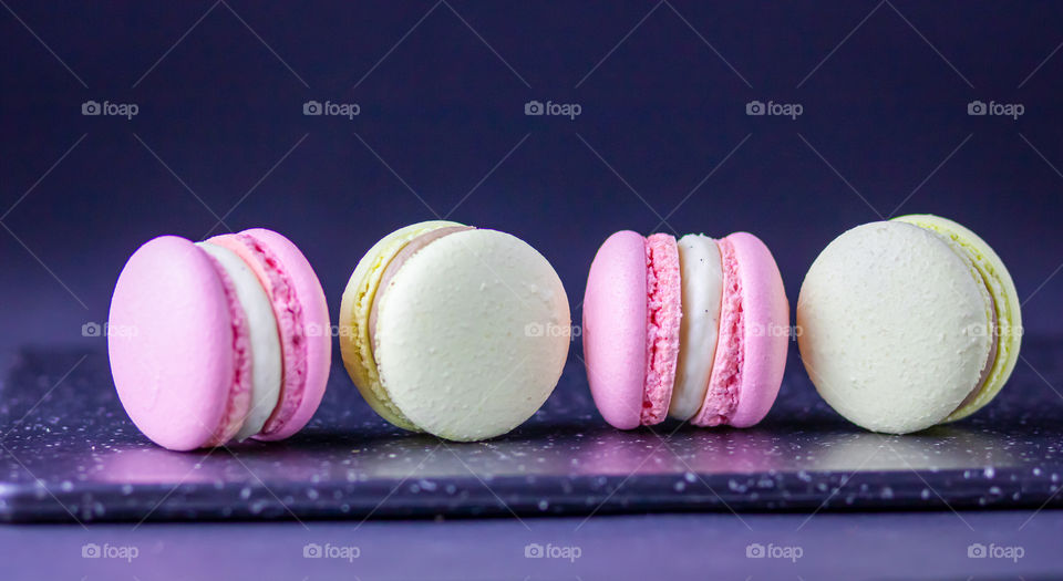 Macarons with cream in pastel colours.