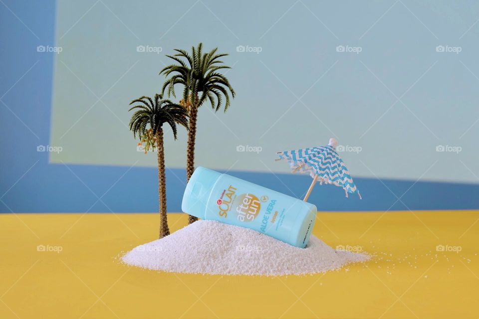 Blue colored tube on yellow surface and against blue background. 