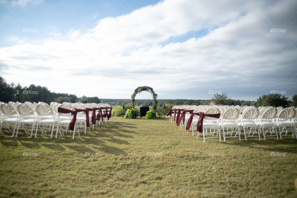 Wedding ceremony decor with red bows and ribbons