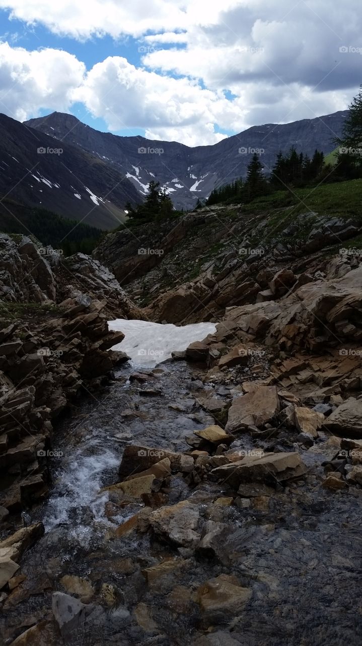 Patches of snow in the rocks of a high mountain valley in the Rocky Mountains
