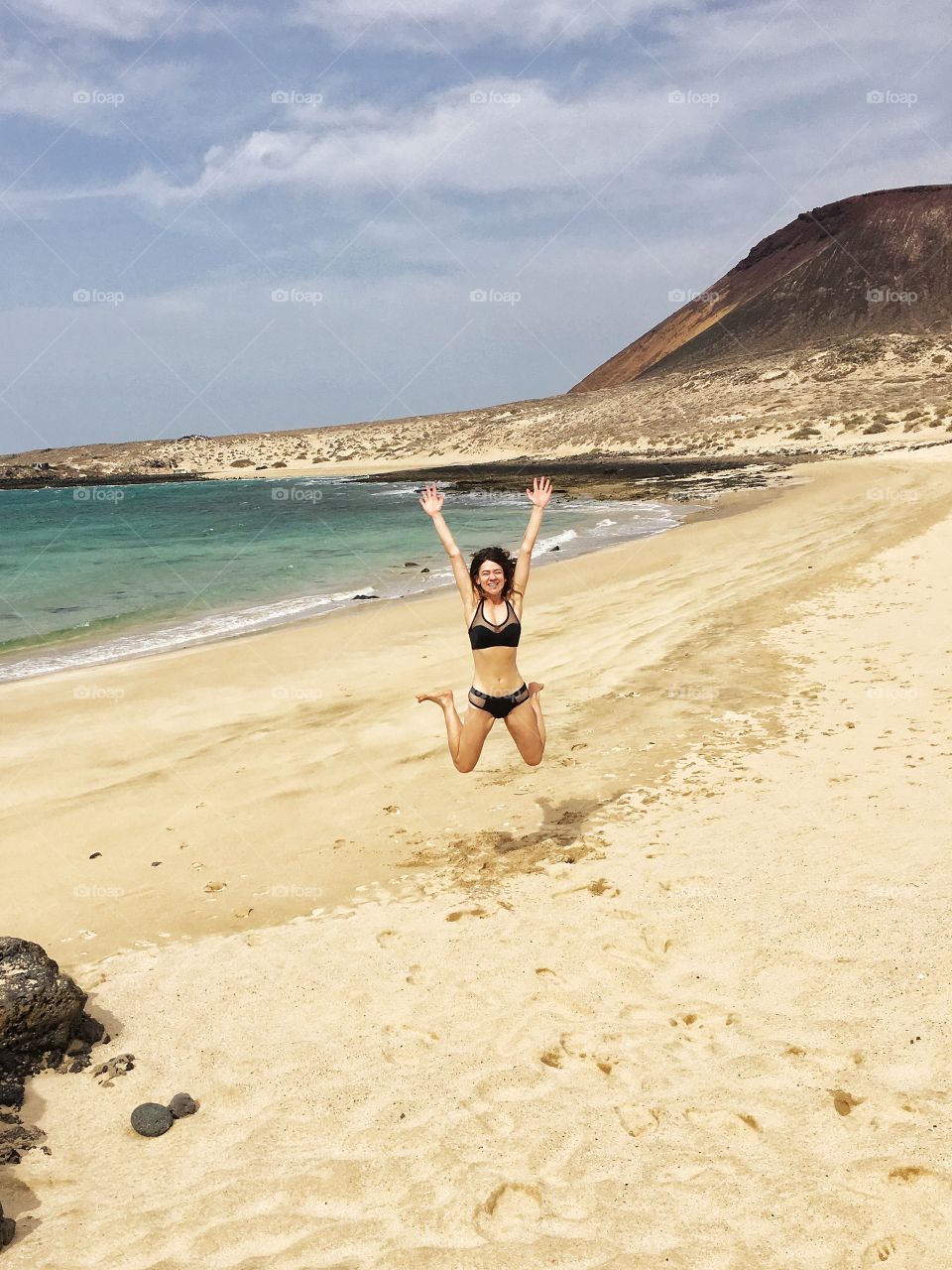 Girl jumping on a beach