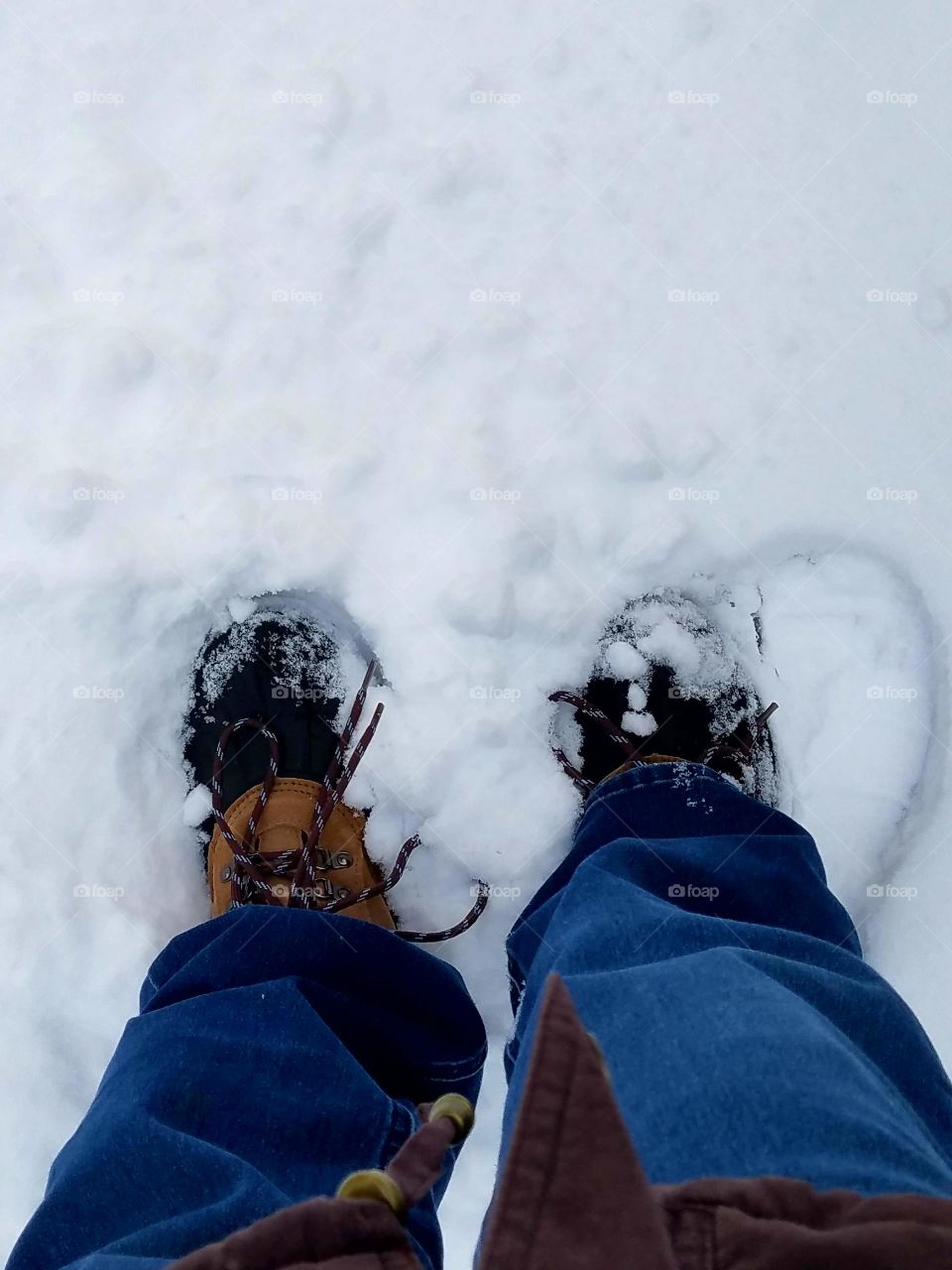 Standing in snow with boots on.