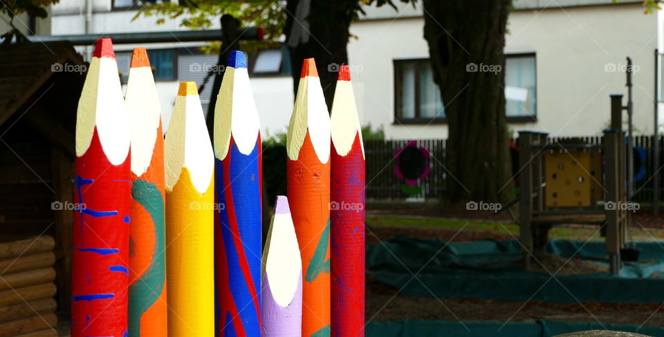 a fence of colored pencils