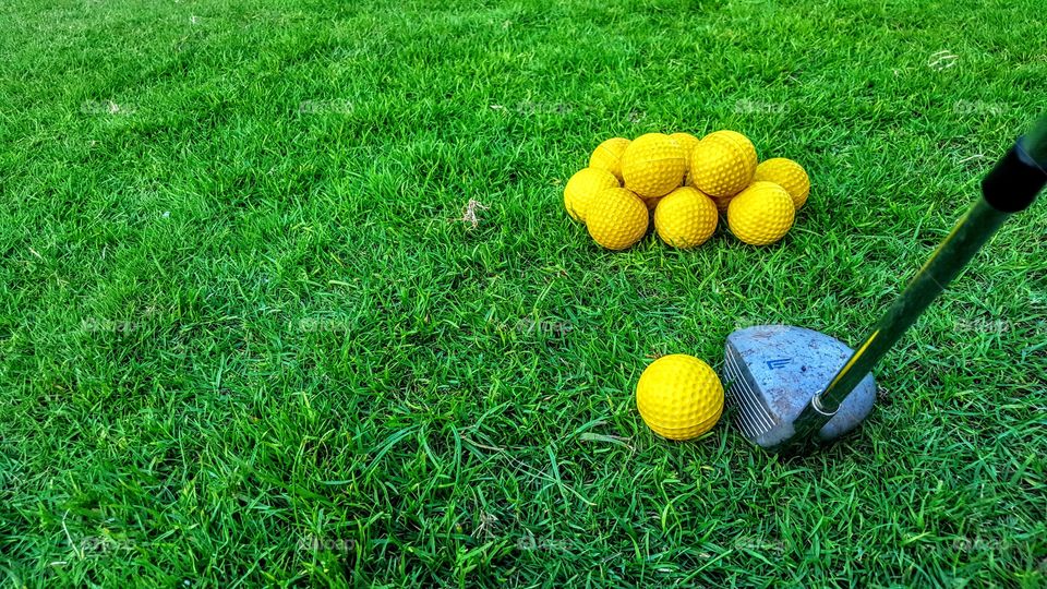 Yellow golf ball with golf club