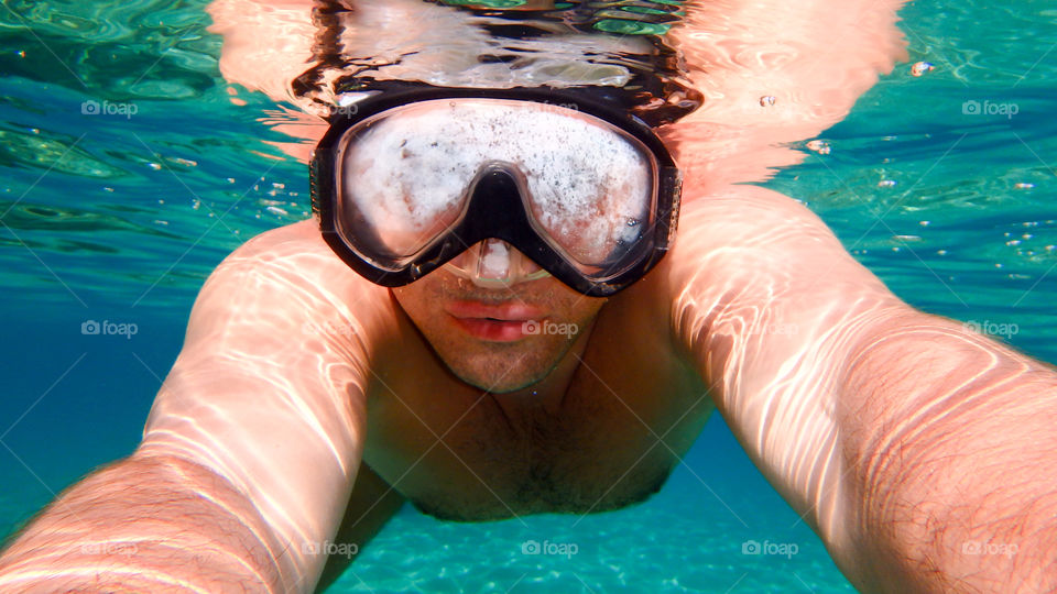 Underwater man swimming in sea