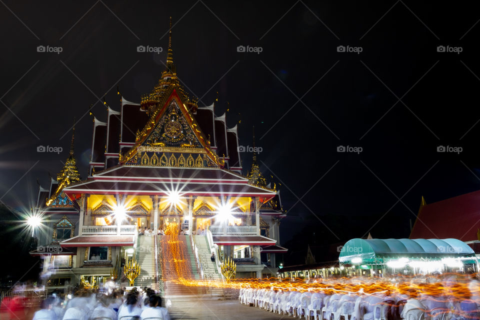 Thailand-Febuary 08 2019:Line of candle in Monks' hand while walk around the pagoda with candle at Wat Asokkaram in Magha Puja Day is held on the Day of the full moon of the third lunar month