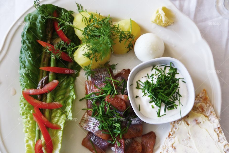 Potatoes, herring, vegetables and herbs 