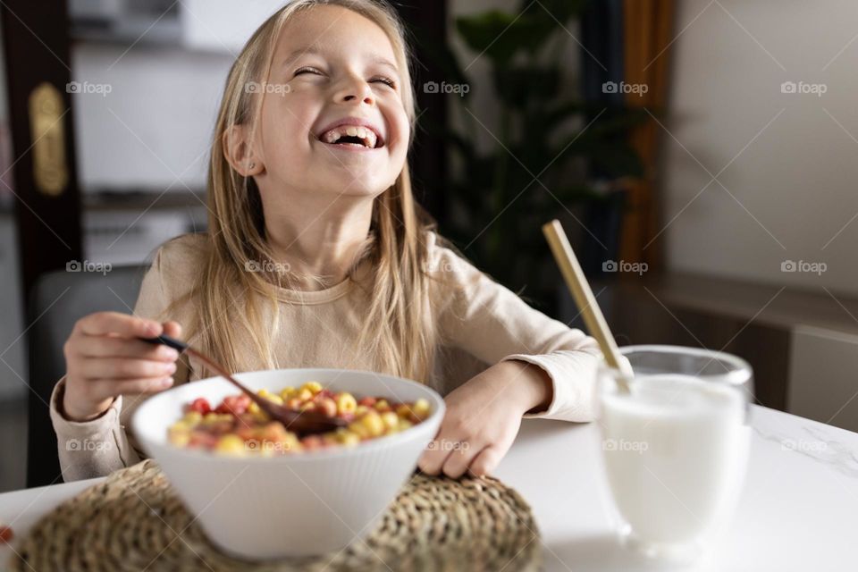 Happy kid having breakfast 