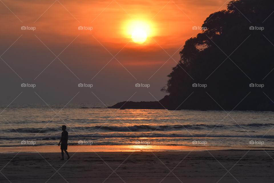 man on the beach during sunset