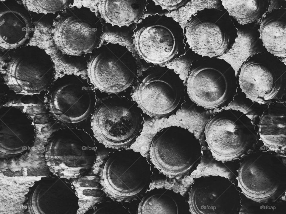 Black and white still life of bottle caps