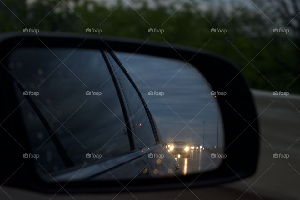 Looking at the rear view mirror in traffic