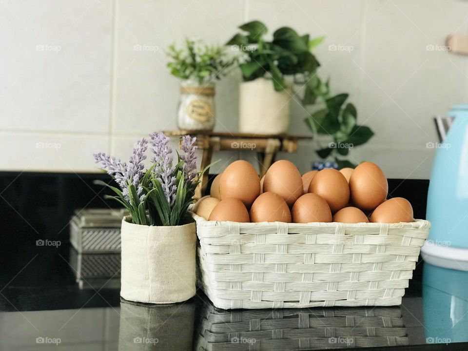 Eco friendly reusable eggs basket and plant pots and background covered with wooden stand and reusable plant containers with plants 🌱