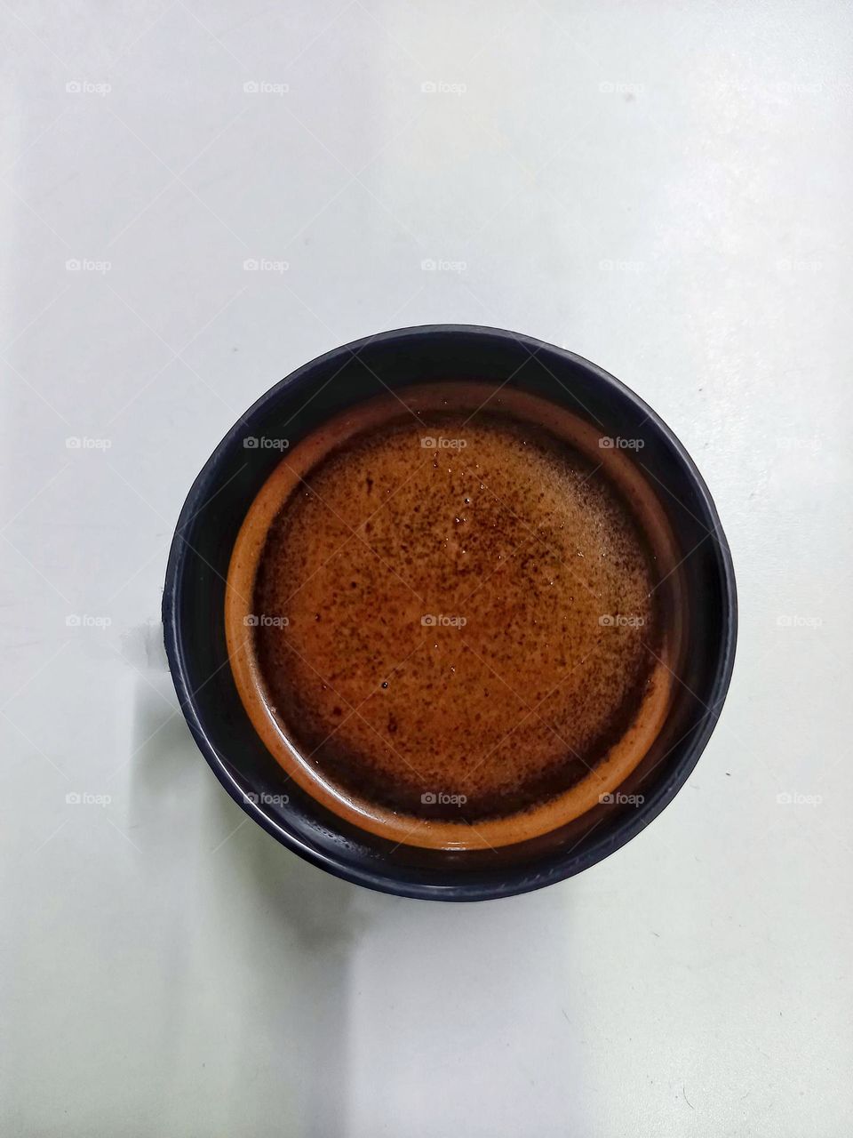 A cup of black coffee.