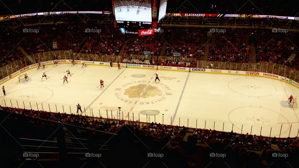 Hockey arena. This is a picture of the Chicago Blackhawks hockey arena/ ice during a game.