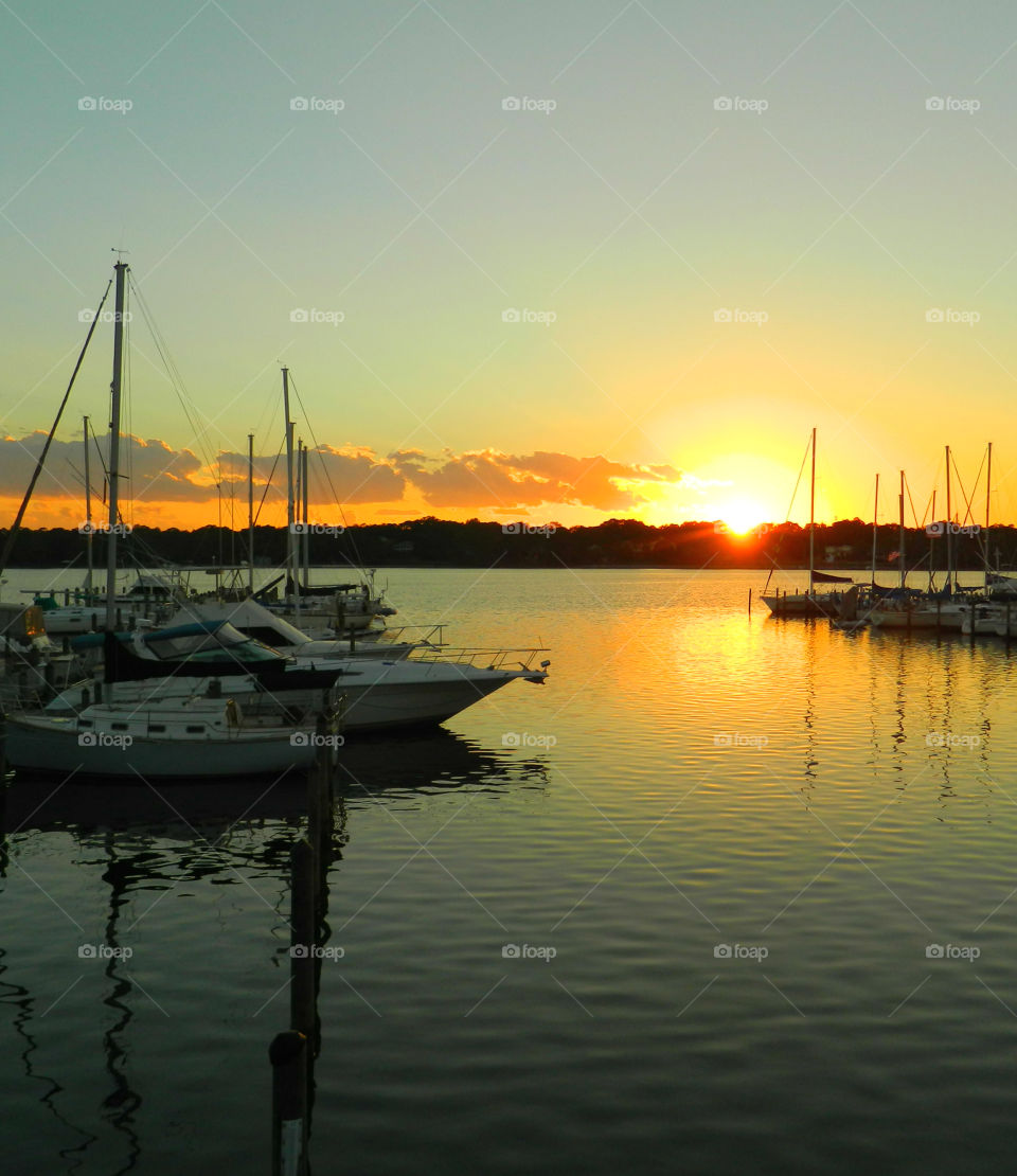 Sail boat on sea at sunset