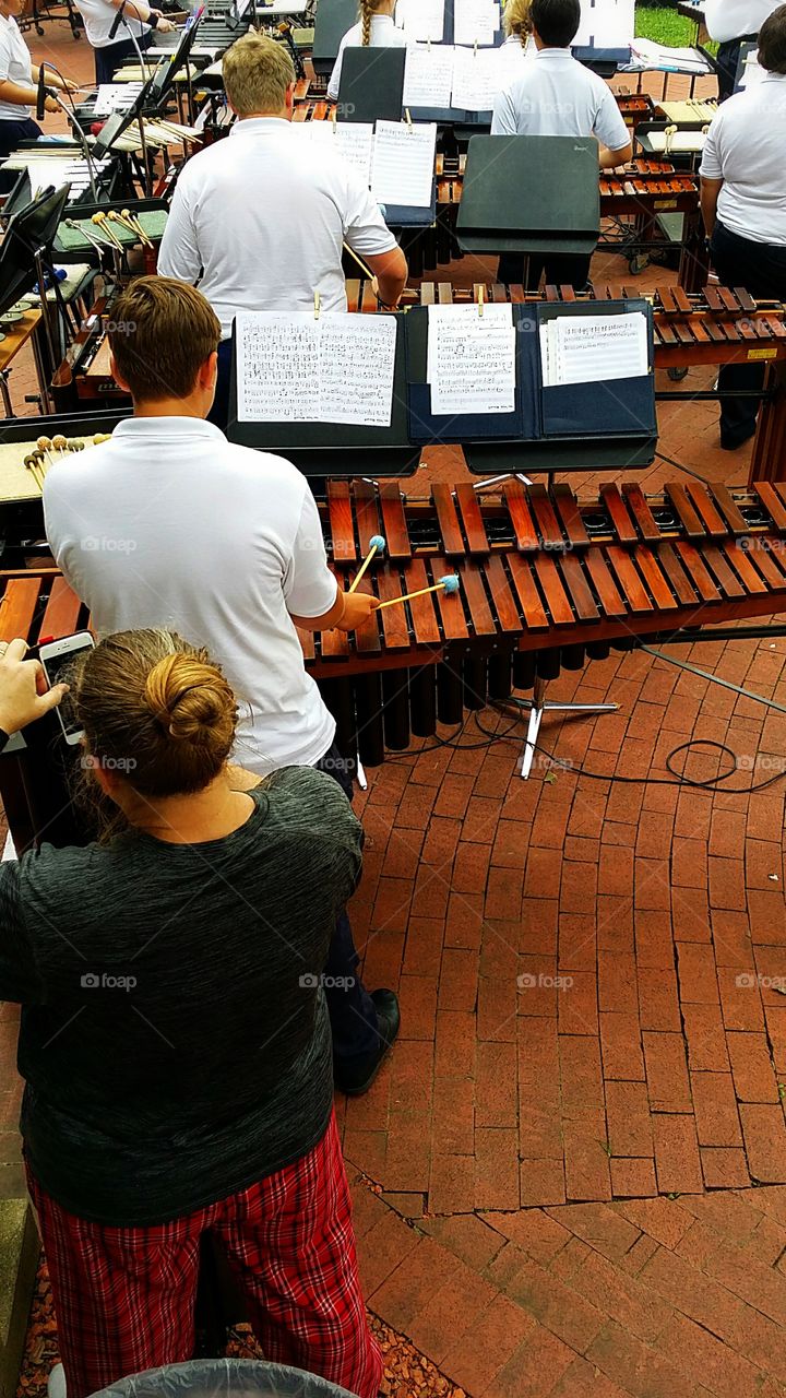 percussion Orchestra playing outdoor concert wood xylophone