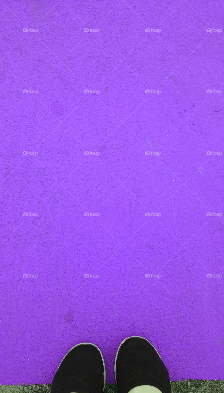 Person standing near purple background