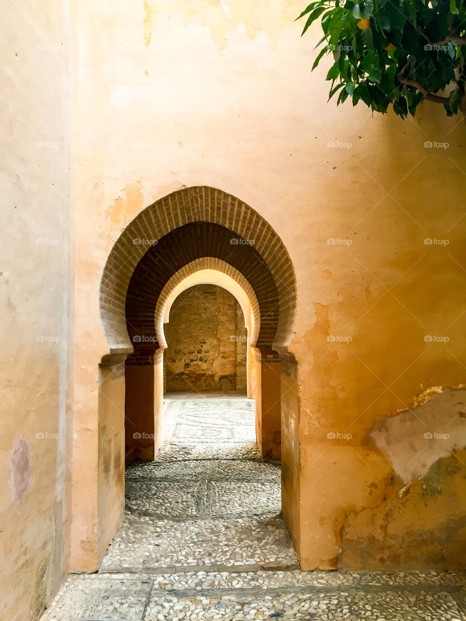 Moorish doorway and entrance to Alhambra palace in Spain featuring old rustic walls