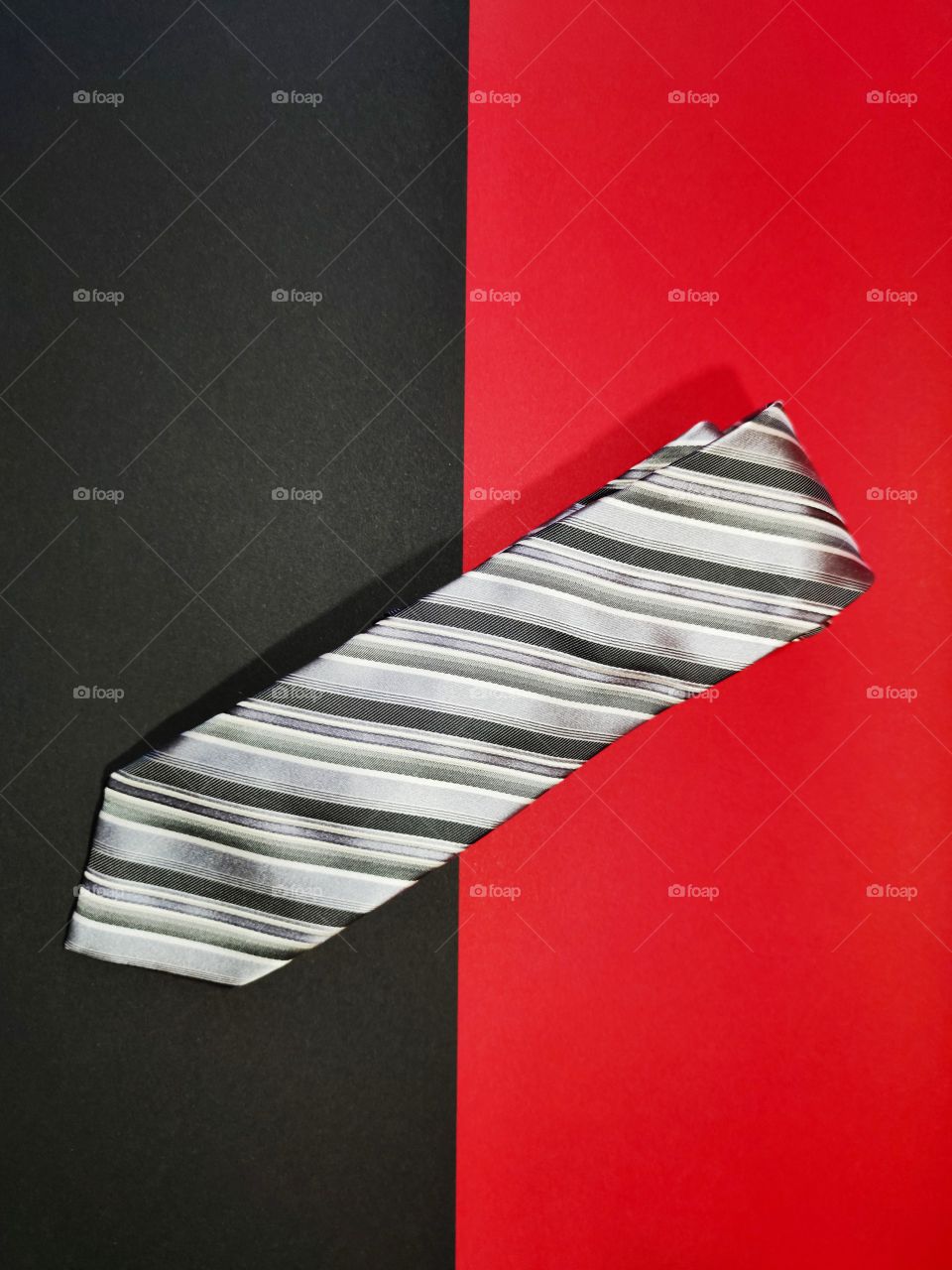 Gray tie on red and black background