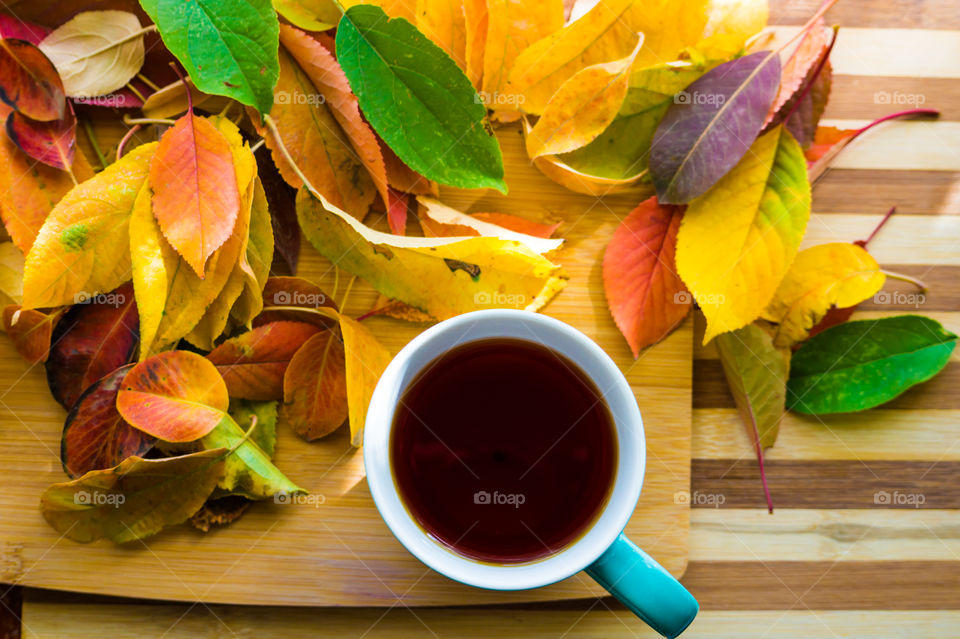 Hot flower tea in a blue mug on a wooden background