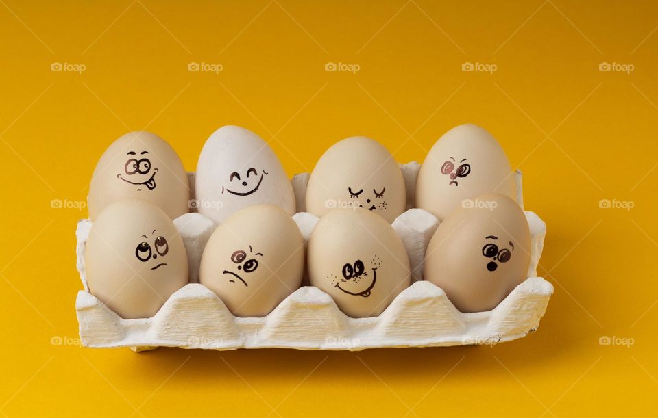 Funny smiling smileys eggs on yellow