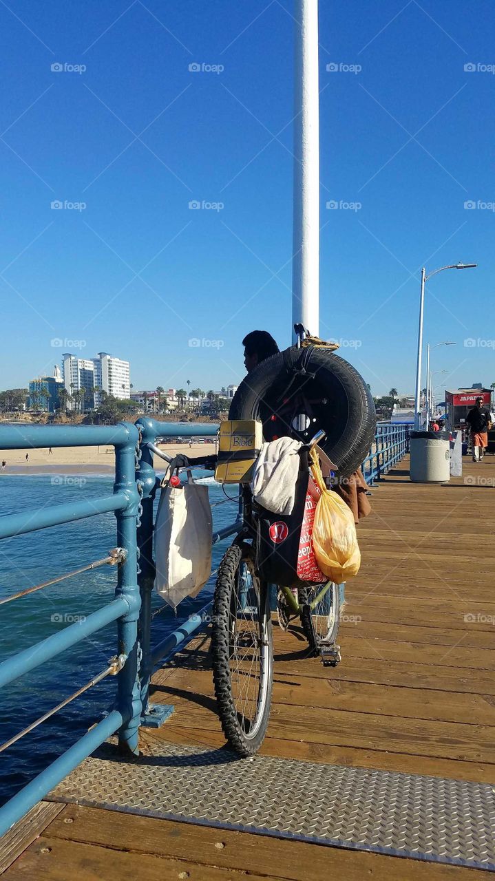 Santa Monica pier man with alligator head, tire and bible.