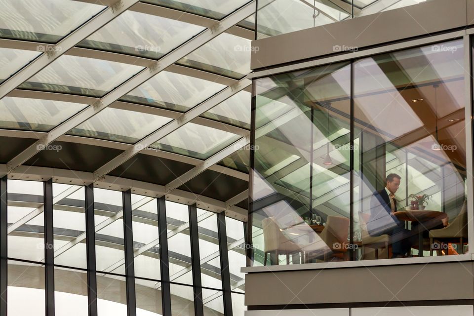 Modern interior in Sky Garden, London. Man at the bar in Sky Garden, London