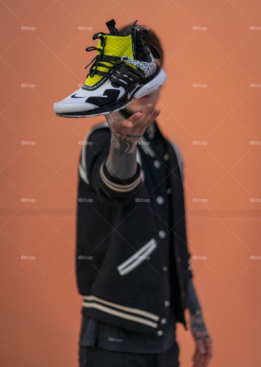 man holding sports shoes