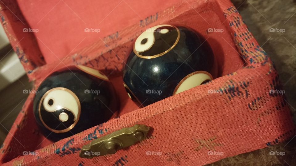 Chinese yin-yang meditation balls. A pair of Chinese meditation balls with yin-yang decorations, in a small velvet-lined box...