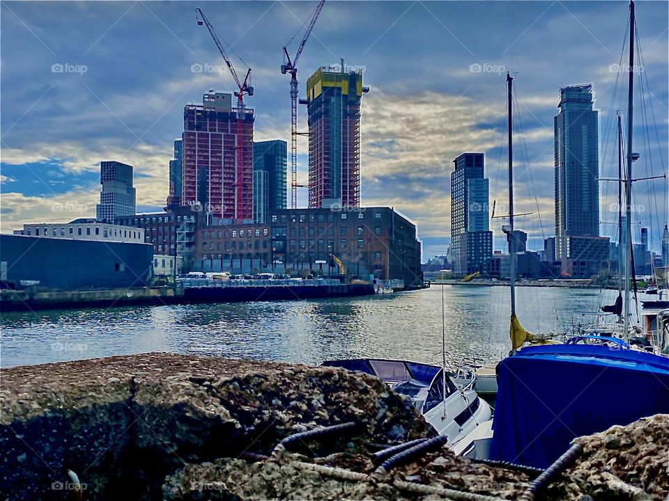 “Newtown Creek” seen from beneath the Pulaski Bridge in LIC, Queens on a late afternoon in April 2022. Nuances of blue in the sky and the waters of the E River repeat as they are reflected from above to below and back. Hypnotic Productions