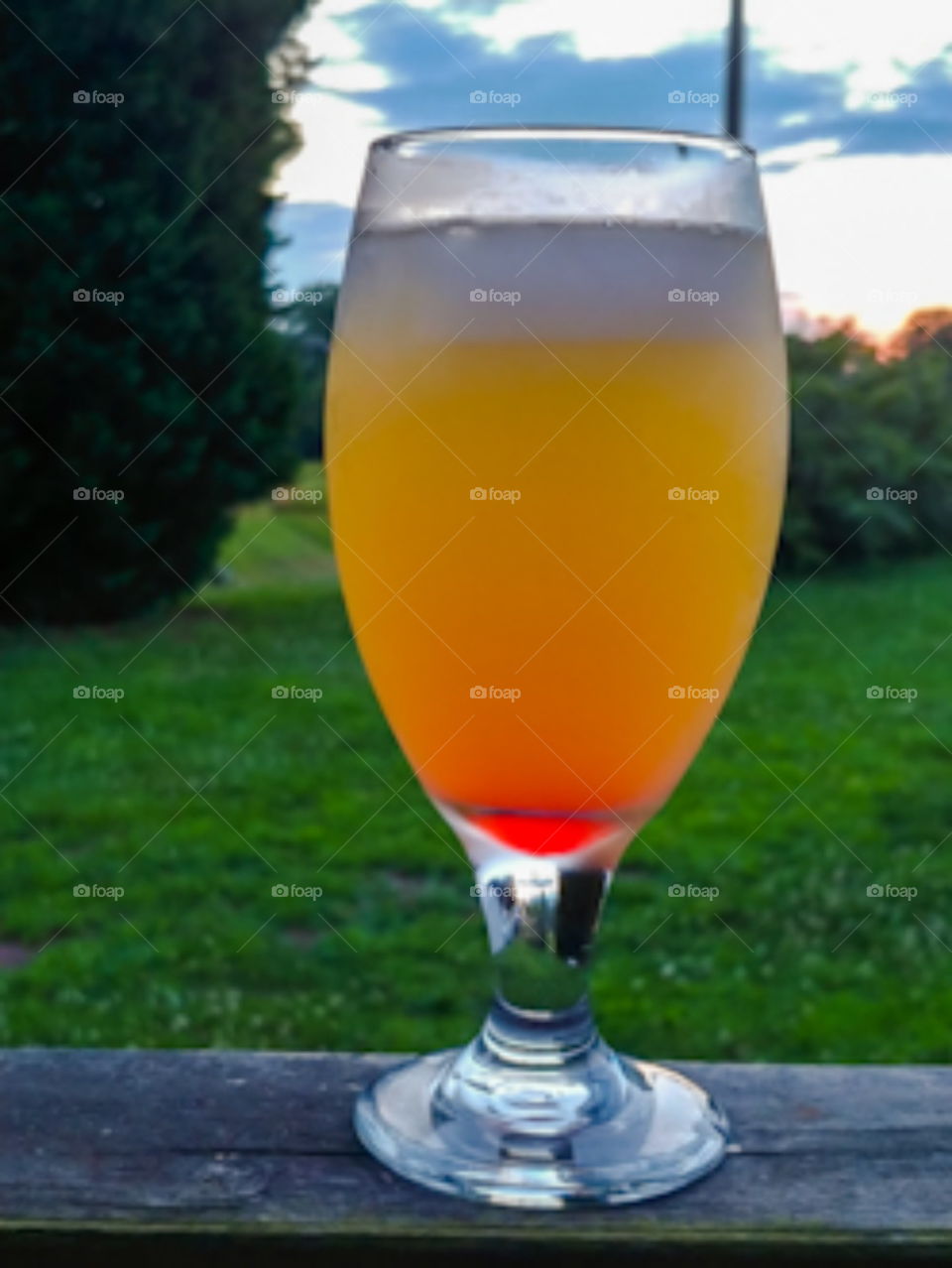 Cool spritzer Drink in a glass on a summers evening. Orange and Red. mimosa