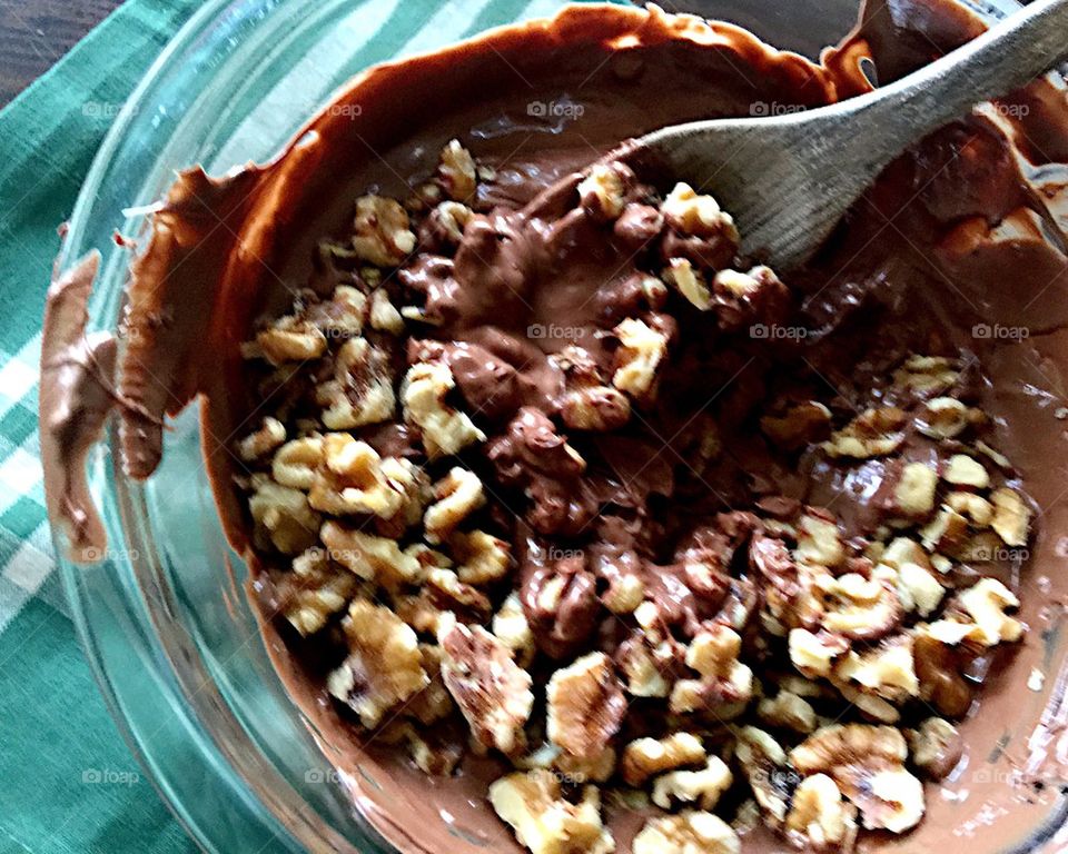 Stirring walnuts into melted chocolate