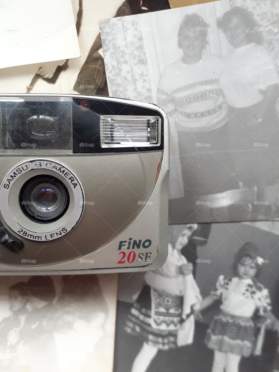 original photo retro camera 2000s with old photos depicting happy people