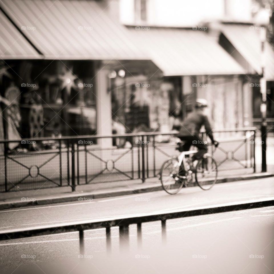 Man on bike in shopping street 