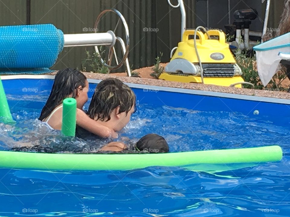 Swimming pool fun. Children playing in the swimming pool