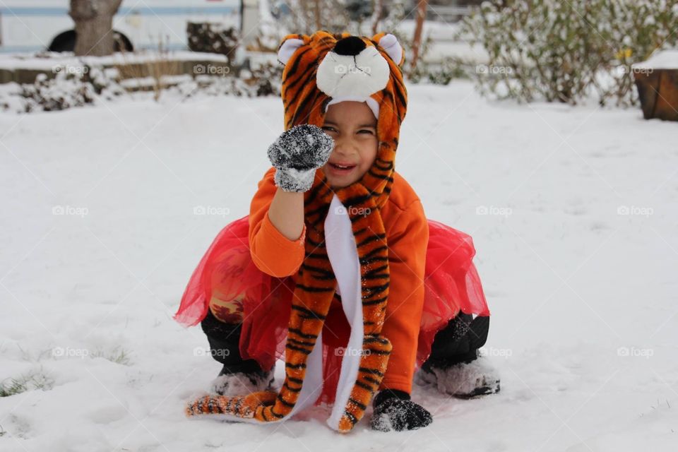 Cute girl with animal mask on snowy weather