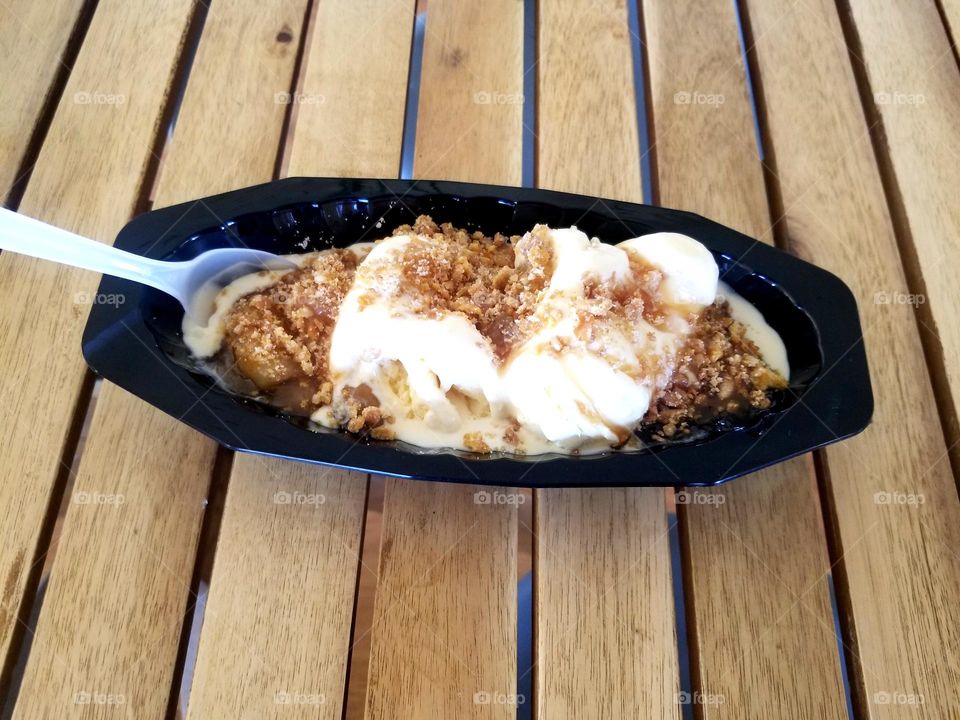 Icecream sundae on a plain natural wood table