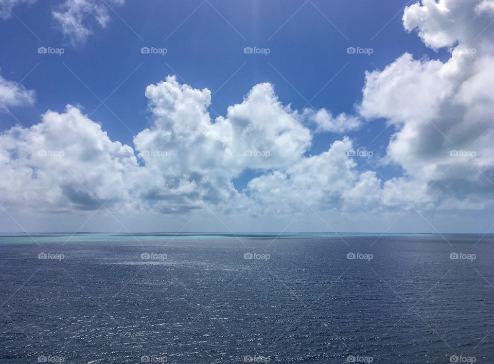 A beautiful morning on the ocean.  Blue sky, blue water, sparkling from the sun shining down.  